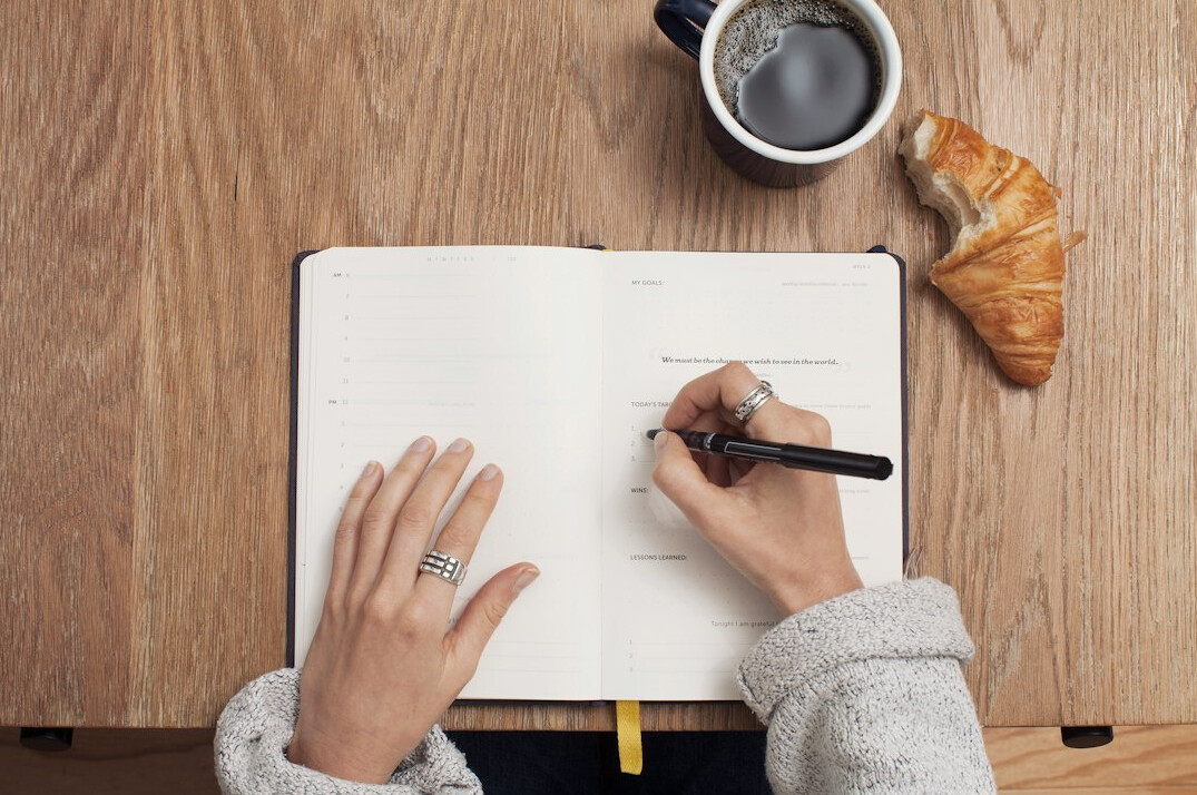 person writing in planner