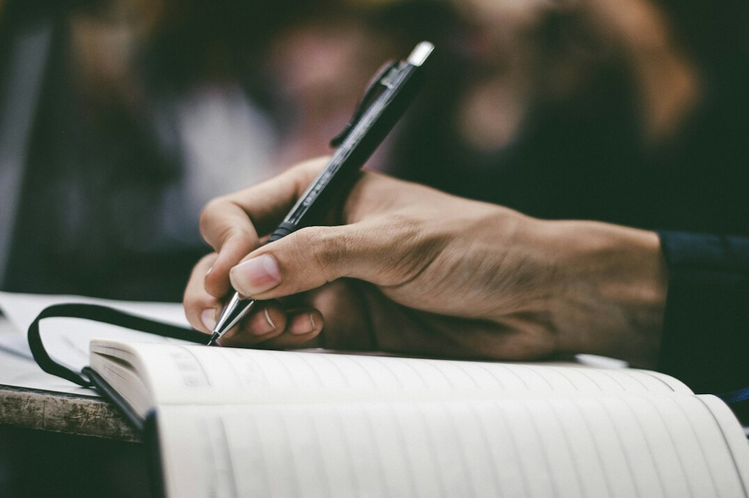 person writing in planner