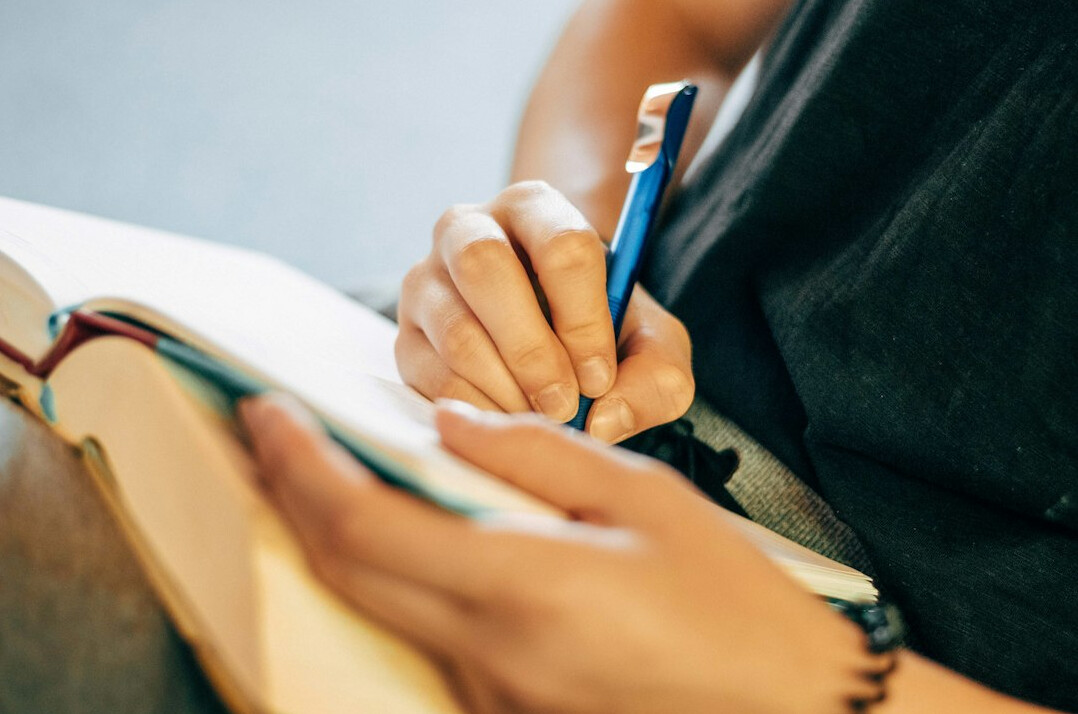 person writing in planner